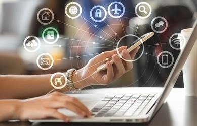 Person using a laptop with connected service icons overlaid
