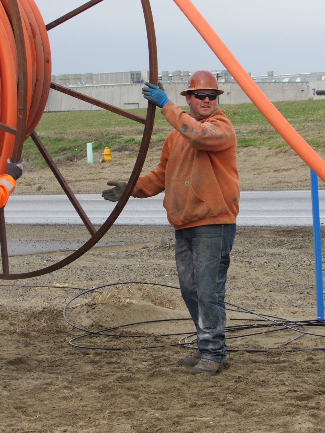 Windwave crew working at sunrise beside a cable plow